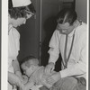 Woodville, California. FSA (Farm Security Administration) farm workers' community. Doctor examining child of agricultural workers at the clinic