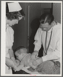 Woodville, California. FSA (Farm Security Administration) farm workers' community. Doctor examining child of agricultural workers at the clinic