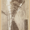 Two groups of seated people, facing each other, in unidentified building in Japan