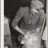 Woodville, California. FSA (Farm Security Administration) farm workers' community. Carding surplus cotton which will be used for quilts
