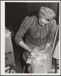 Woodville, California. FSA (Farm Security Administration) farm workers' community. Carding surplus cotton which will be used for quilts