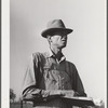 Woodville, California. FSA (Farm Security Administration) farm workers' community. Checking cotton pickers. He is a resident of the community