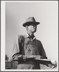 Woodville, California. FSA (Farm Security Administration) farm workers' community. Checking cotton pickers. He is a resident of the community