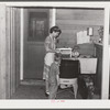 Woodville, California. FSA (Farm Security Administration) farm workers' community. Wife and son of an agricultural worker who live in a garden house