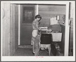 Woodville, California. FSA (Farm Security Administration) farm workers' community. Wife and son of an agricultural worker who live in a garden house