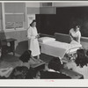 Eleven Mile Corner, Arizona. FSA (Farm Security Administration) farm workers' community. The nurse, who divides her time between work at the hospital and NYA instruction, teaching girls who live at the NYA resident center how to make a bed properly