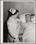 Eleven Mile Corner, Arizona. Cairns General Hospital. FSA (Farm Security Administration) farm workers' community. Nurse taking temperature of a patient