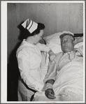Eleven Mile Corner, Arizona. Cairns General Hospital. FSA (Farm Security Administration) farm workers' community. Nurse taking temperature of a patient