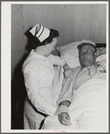 Eleven Mile Corner, Arizona. Cairns General Hospital. FSA (Farm Security Administration) farm workers' community. Nurse taking temperature of a patient