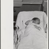 Baby in the nursey at the Cairns General Hospital at the FSA (Farm Security Administration) farm workers' community. Eleven Mile Corner, Arizona