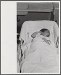 Baby in the nursey at the Cairns General Hospital at the FSA (Farm Security Administration) farm workers' community. Eleven Mile Corner, Arizona