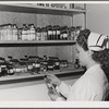 Eleven Mile Corner, Arizona. Cairns General Hospital, FSA (Farm Security Administration) farm workers' community. Nurse getting medicine from the storeroom