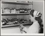 Eleven Mile Corner, Arizona. Cairns General Hospital, FSA (Farm Security Administration) farm workers' community. Nurse getting medicine from the storeroom