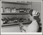 Eleven Mile Corner, Arizona. Cairns General Hospital, FSA (Farm Security Administration) farm workers' community. Nurse getting medicine from the storeroom
