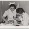 Resident doctor at the Cairns General Hospital attends boy who has been burned. FSA (Farm Security Administration) farm workers' community. Eleven Mile Corner, Arizona