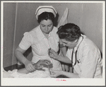 Resident doctor at the Cairns General Hospital attends boy who has been burned. FSA (Farm Security Administration) farm workers' community. Eleven Mile Corner, Arizona