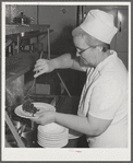 Dishing up vegetables at lunchtime at the Cairns General Hospital at the FSA (Farm Security Administration) farm workers' community. Eleven Mile Corner, Arizona