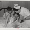 Eleven Mile Corner, Arizona. Cairns General Hospital, FSA (Farm Security Administration) farm workers' community. Nurse removing a patient's bandage