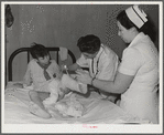 Resident doctor at the Cairns General Hospital changes dressing on boy who was badly burned. Eleven Mile Corner, Arizona