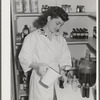 Eleven Mile Corner, Arizona. Cairns General Hospital, FSA farm workers' community. NYA (National Youth Administration) girl bottling medicine. The NYA girls, who live at the resident center, receive training as nurses helpers