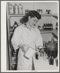 Eleven Mile Corner, Arizona. Cairns General Hospital, FSA farm workers' community. NYA (National Youth Administration) girl bottling medicine. The NYA girls, who live at the resident center, receive training as nurses helpers