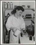 Eleven Mile Corner, Arizona. Cairns General Hospital, FSA farm workers' community. NYA (National Youth Administration) girl bottling medicine. The NYA girls, who live at the resident center, receive training as nurses helpers
