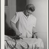 Eleven Mile Corner, Arizona. Cairns General Hospital, FSA (Farm Security Administration) farm workers' community. NYA (National Youth Administration) girl who lives in the resident center working in the laundry