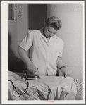 Eleven Mile Corner, Arizona. Cairns General Hospital, FSA (Farm Security Administration) farm workers' community. NYA (National Youth Administration) girl who lives in the resident center working in the laundry