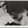 Eleven Mile Corner, Arizona. Cairns General Hospital, FSA (Farm Security Administration) farm workers' community. Resident doctor dressing a burn