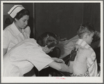 Eleven Mile Corner, Arizona. Cairns General Hospital, FSA (Farm Security Administration) farm workers' community. Resident doctor dressing a burn