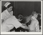 Eleven Mile Corner, Arizona. Cairns General Hospital, FSA (Farm Security Administration) farm workers' community. Resident doctor dressing a burn
