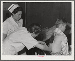 Eleven Mile Corner, Arizona. Cairns General Hospital, FSA (Farm Security Administration) farm workers' community. Resident doctor dressing a burn