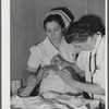 Eleven Mile Corner, Arizona. Cairns General Hospital, FSA (Farm Security Administration) farm workers' community. Resident doctor and nurse attending a patient