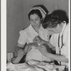 Eleven Mile Corner, Arizona. Cairns General Hospital, FSA (Farm Security Administration) farm workers' community. Resident doctor and nurse attending a patient