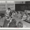 Eleven Mile Corner, Arizona. FSA (Farm Security Administration) farm workers' community. Home economics teacher demonstrating to schoolgirls the proper methods of preparing various foods