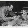 Eleven Mile Corner, Arizona. FSA (Farm Security Administration) farm workers' community. Agricultural worker and his son in the workshop