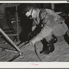 Pinal County, Arizona. Defense training project, U.S. Department of Education. Ranch boys learning welding. This man came to Arizona from Texas, learned welding, and is now working, but comes back to school at night to learn more about the subject