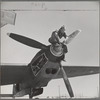 Working on the propeller hub of an interceptor plane. Lake Muroc, California