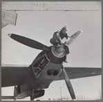 Working on the propeller hub of an interceptor plane. Lake Muroc, California