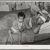 Mexican father and child. San Antonio, Texas. This family was living on relief. The father was obviously very sick. He said he had kidney trouble. He was having no medical attention