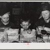 Woodville, California. FSA (Farm Security Administration) farm workers' community. Little boys eyeing cakes in the cooperative store