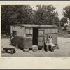 WPA (Works Progress/Work Projects Administration) worker and his wife sitting in front of their shack home on the Arkansas River near Webbers Falls, Oklahoma