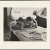 Children reading Sunday papers, Rustan brothers' farm near Dickens, Iowa. Note convenience of running water in background. This farm was formerly owner operated but they are now tenants of Metropolitan Life