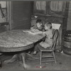 Children of Frank Weeks looking through a catalogue