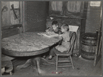 Children of Frank Weeks looking through a catalogue