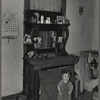 Baby in front of dresser in John Baker's farm home. Divide County, North Dakota