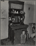 Baby in front of dresser in John Baker's farm home. Divide County, North Dakota