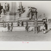 Tourists arriving at Washington, D.C. Throwing pennies to colored boys in fountain across from Union Station