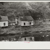 Houses in abandoned mining town with remains of coal tipple at right, Mohegan, West Virginia