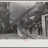 Miners starting home after work. Part of coal tipple shown at left. West Virginia
